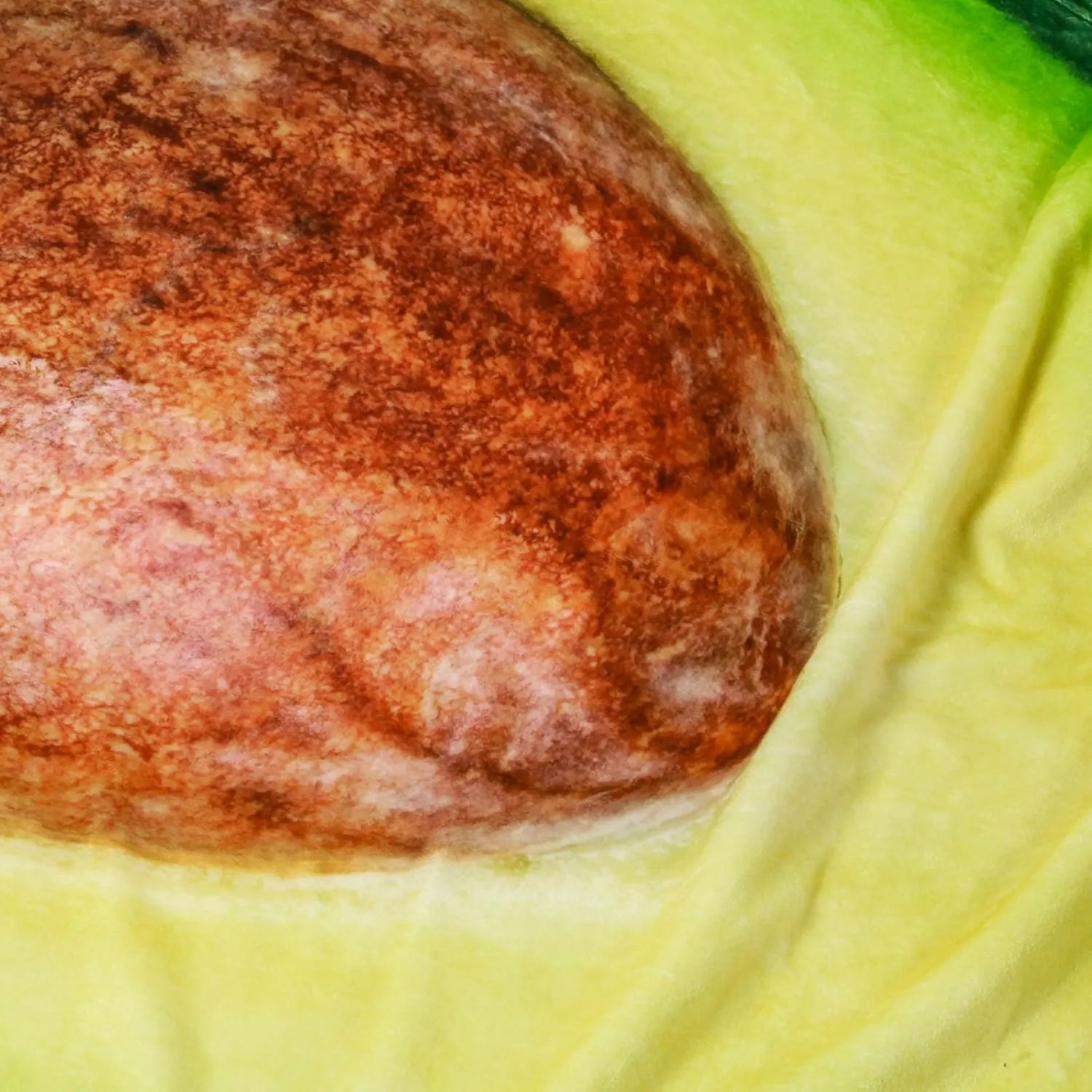 Giant round avocado blanket printed like a whole avocado with the pit